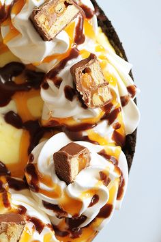 there is a chocolate pie with ice cream and caramel on top, topped with marshmallows