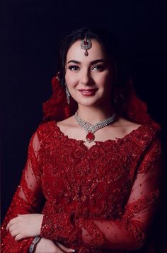 a woman in a red dress posing for a photo with her hands on her hips