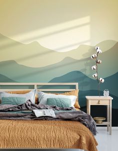 a bedroom with mountains painted on the wall and a bed in the foreground,