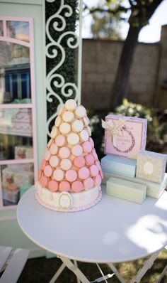 there is a small cake on top of a table with other items in front of it