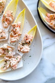 lobster appetizers with lemon wedges on a white plate