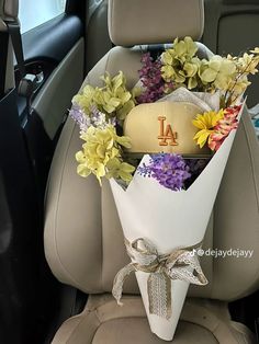 flowers in the back seat of a car with a hat on it's head