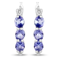 "Tanzanite Earrings, Natural Tanzanite 3-Stone Hinged Hoop Earrings in .925 Sterling Silver, December Birthstone Olivia Leone Jewelry Flaunt yourself with these tanzanite & white diamond hinged hoop earrings. The natural gemstones have a combined weight of 1.99 carats and are set in .925 sterling silver with rhodium plating. The soft violet hue of these earrings adds a pop of color to any look! The understated design and vibrant stones make these earrings perfect for every occasion. Product Tanzanite Earrings With Prong Setting, White Gold Tanzanite Gemstone Earrings, Tanzanite Birthstone Earrings For Gifts, Tanzanite Three-stone Round Jewelry, Blue Tanzanite Round Earrings, December Jewelry, Tanzanite Bracelet, Oval Stud Earrings, Tanzanite Jewelry