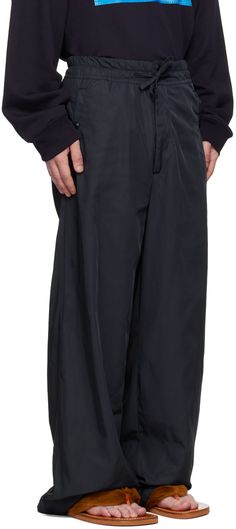 Loose-fit polyester taffeta track pants. · Drawstring at elasticized waistband · Four-pocket styling · Zip-fly Supplier color: Navy Nylon Bottoms With Elastic Waistband For Work, Wide-leg Nylon Pants With Elastic Waistband, Nylon Wide-leg Pants With Elastic Waistband, Nylon Parachute Pants With Side Pockets For Work, Nylon Cargo Pants For Workwear, Nylon Tapered Leg Pants With Side Pockets, Straight Nylon Pants With Side Pockets, Nylon Tapered Leg Pants, Wide Leg Nylon Workwear Pants