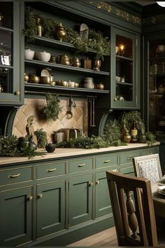 a kitchen with green cabinets and gold trim on the counter tops, along with candles