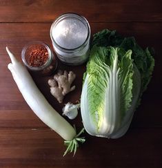 lettuce, carrots, garlic and seasoning on a wooden table