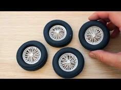 four toy wheels are sitting on a table