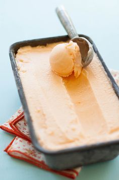 a scoop of ice cream in a pan with a spoon