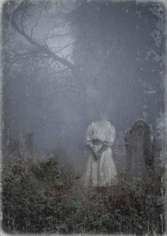 an old cemetery with a ghostly figure in the fog