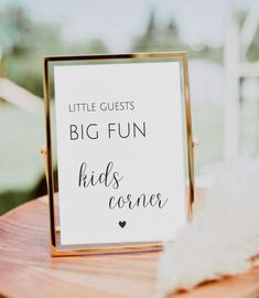 a sign that says little guests big fun kids come on top of a wooden table