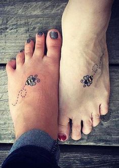 two people with tattoos on their feet standing next to each other and one has a bee tattoo on it