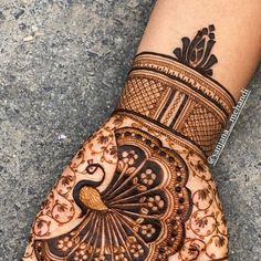 a henna tattoo on the palm of someone's hand with an intricate design