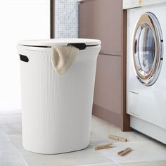 a laundry basket next to a washing machine