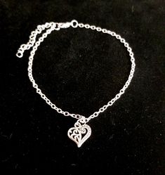 New Handmade Scroll Heart Anklet ~ Stainless steel anklet chain and charm will not tarnish ~ Scroll heart charm ~ Available in several lengths ~ Includes a 2 inch extender ~ Hypoallergenic, Nickle free ~ Ships within 24 hours of purchase Monday-Saturday Gift Packaging & Messages: Your item will be lovingly packaged and labeled as a handmade item.  Item's that ship with gift boxes are stated in the description. Handwritten gift notes available, just include a gift message with your order. Gift packaging also available for purchase at checkout for jewelry item.  Shipping:  * USPS First Class: 3-5 business days * USPS Priority: 2-3 business days *I ship within 24 hours of purchase. Please note that transit time estimates are based on the shipping method you select and are subject to change du Adjustable Heart-shaped Anklets For Valentine's Day, Dainty Adjustable Anklets For Valentine's Day, Adjustable Heart-shaped Dainty Anklets, Adjustable Heart Metal Anklets, Heart-shaped Metal Anklets For Gift, Heart-shaped Metal Anklets As Gift, Adjustable Heart Charm Anklets, Adjustable Heart-shaped Metal Anklet, Elegant Adjustable Anklets With Heart Charm