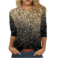 a woman wearing a black and gold top with sequins on the front,