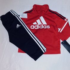 New With Tags. Adidas Boys Toddler Polyester Blend Warmer Set. Red & Black With White Trim And 2 Pocket Design With Full Zip Front. Banded Wrist Opening Offers Comfort Placement With "Adidas" Inscription On Front Of Jacket Top. The Bottoms Are Black With Elastic Waistband With Adidas Inscription On Left Upper Leg With 3 Stripes Down Each Outer Leg. Set First 12 Months Infant Boys. Great Set At A Great Price. Any Questions Please Contact Me. Thanks!!!! Red Sports Sets For Spring, Red Cotton Sports Set, Adidas Fitted Winter Sets, Winter Adidas Fitted Sets, Red Playtime Sets For Fall, Sporty Red Long Sleeve Set, Adidas Cotton Sets For Winter, Adidas Cotton Winter Sets, Red Playtime Sets For Winter