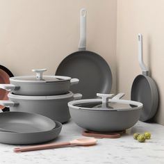 grey pots and pans are sitting on the table