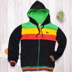 "Thick, fleshy Rasta zip hoodie, made in a fleece-back fabrics. Tightly woven fabric, lightweight design: Cotton 90%, polyester 10%. It features a unisex straight, comfortable regular fit and zip. This hoodie has a double-lined hood and metal grommets. Lion of Judah print on the chest. Logo patch at the bottom: Roots & Culture. Small side insert in Rasta colors. Color: Black & Rasta. Product made in Poland. High quality product, made of the cotton yarn holding certificates: Oeko Tex Standard 100