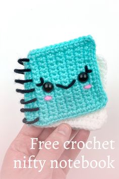 a small crocheted book with eyes and hair on it's cover is shown