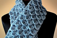 a blue crocheted scarf on top of a mannequin