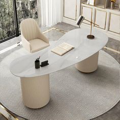 an oval table with two chairs and a book on it