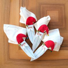 four pieces of cloth with red and white decorations on them