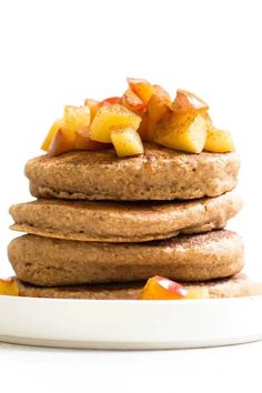 a stack of pancakes with apples on top