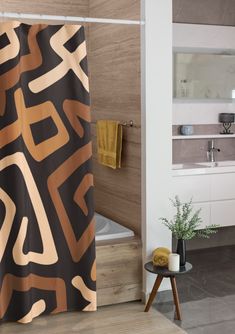 a bathroom with a bathtub, sink and shower curtain that has an abstract design on it