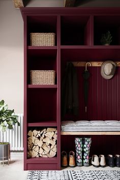 a red bookcase filled with lots of books next to a white radiator