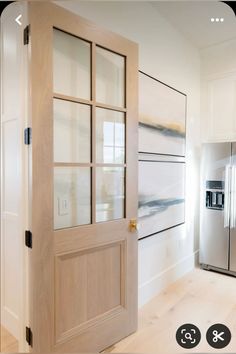 an open door leading to a refrigerator in a kitchen