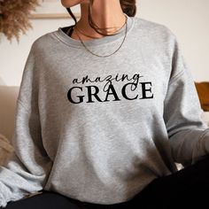 This Amazing Grace Sweatshirt for women is a sleek, soft and stylish way to wear your faith! It's everything you could want for a cool Christian sweatshirt. Women's Christian sweatshirts with faith-based messages are a simple way to share your faith with anyone. You may never need to say a word or even know how a stylish Christian women's sweatshirt can make a positive impression on someone's heart that you passby, or start a meaningful conversation that only takes a few moments. This cute Amazi Custom Text Sweatshirt With Relaxed Fit For Fall, Casual Fall Tops With Custom Text, Inspirational Text Print Fall Sweatshirt, Christian Sweatshirts, Christian Hats, Comfy Casual Outfits, Joggers Outfit, Christian Sweatshirt, Sweatshirt For Women