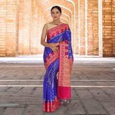 Introducing The Banarasi Malai Silk Sari - A Luxurious And Regal Piece That Is Sure To Turn Heads. This Stunning Sari Features A Beautiful Blue Silk Base, With A Stark Contrast Border In Hot Pink. The Unique Diamond Shaped Weave On The Pleats Is A Traditional Benarasi Weave. The Fall And Pico Are Also Done And The Blouse Is Stitched In Size Mentioned, Making It Perfect For Anyone Who Wants To Wear This Gorgeous Sari. Whether You're Attending A Formal Event Or Simply Want To Stand Out From The Cr Designer Blue Saree For Transitional Season, Blue Designer Saree For Transitional Season, Designer Transitional Blue Saree, Royal Blue Designer Traditional Wear For Diwali, Royal Blue Cutdana Dupatta, Blue Paithani Silk Traditional Wear For Navratri, Blue Handloom Traditional Wear For Transitional Season, Semi-stitched Royal Blue Saree, Blue Traditional Wear For Festive Occasions