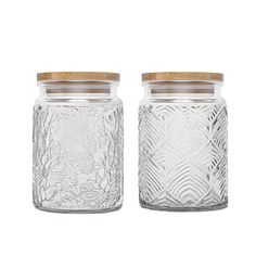 two clear glass jars with wooden lids