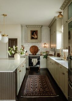 a kitchen with white cabinets and wooden floors