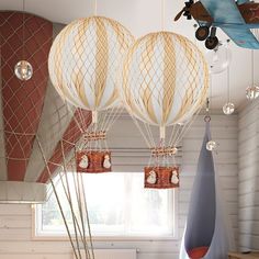 three hot air balloons are hanging from the ceiling