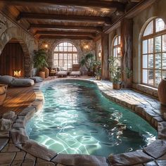 an indoor swimming pool with stone walls and flooring