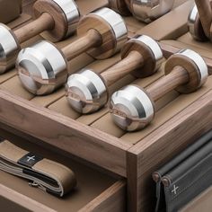 an assortment of wooden and metal knobs in a drawer