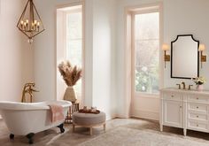 a white bath tub sitting next to two windows