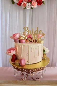 a wedding cake with pink and gold decorations