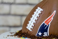 a football cake with chocolate frosting and sprinkles