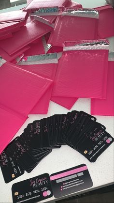 some pink cards are sitting on a table