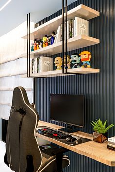 a computer chair sitting in front of a desk with a monitor and keyboard on it