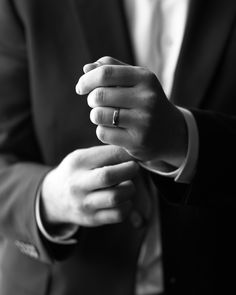 a man in a suit holding his hands together