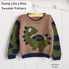 a knitted sweater with a dinosaur on it is hanging from a hook and has the words stomp like a dino sweater pattern