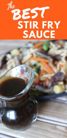 the best stir fry sauce is in a small glass pitcher next to a plate of food