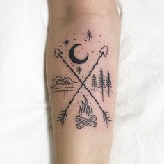 a person with a tattoo on their leg that has a campfire and stars in it