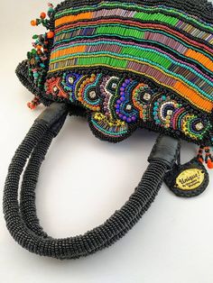 A real piece of art, handcrafted with high-quality Czech glass beads, crystals and glass seed beads. This unique handbag with all details, totally embroidered by hand was made in two months. Stunning and one of a kind piece! So many details with two different embroidery patterns, bottle sides. Definitely, a piece of art made for an exigent woman. **This piece is one of a kind, that it means, that isn't another piece like that. This is what I love to do: unique pieces for exigent women. **Specifi Multicolor Evening Bags With Colorful Beads, Elegant Multicolor Beaded Square Shoulder Bag, Multicolor Beaded Evening Bag, Elegant Multicolor Beaded Bag, Bohemian Purse, Embroidery Purse, Luxury Multicolor Beaded Clutch, Unique Handbag, Elegant Bags