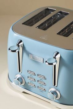 a blue toaster sitting on top of a white counter