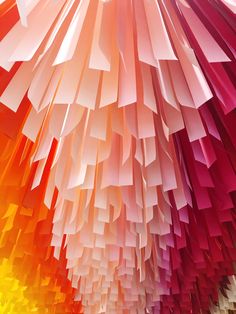 an image of colorful paper hanging from the ceiling