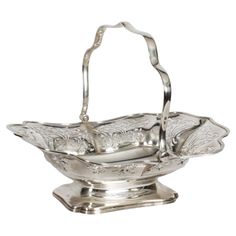 a silver basket with handles on a stand